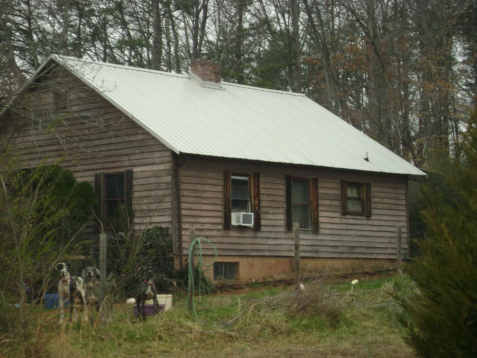 White metal roof on an old wood sided farmhouse, from a Asphalt Shingle Roof Repair job in Unionville